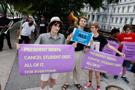 Student loan debt holders take part in a demonstration outside of the white house staff entrance to demand that President Biden cancel student loan debt in August on July 27, 2022, at the Executive Offices in Washington, DC.