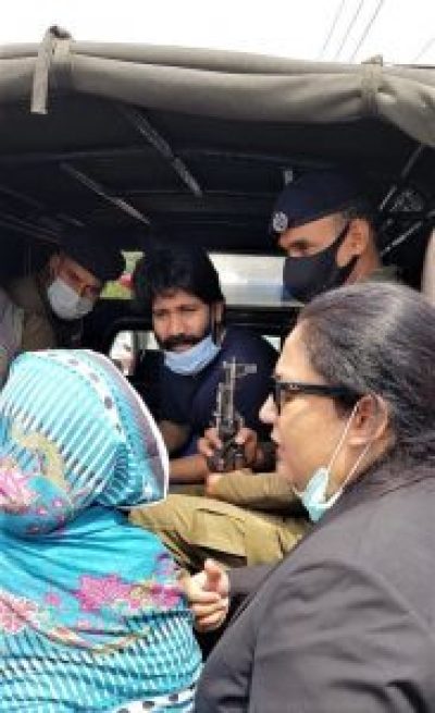 Salamat Mansha Masih (center) sees his mother and former attorney (right) on arrival at jail in Lahore, Pakistan, on April 23, 2021. 