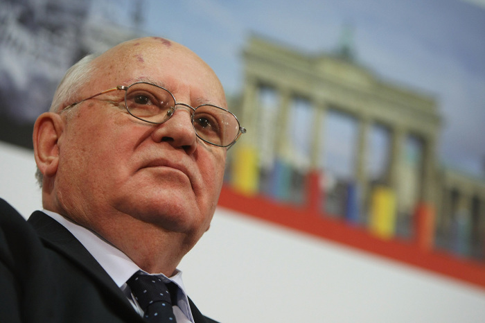 Former Soviet President Mikhail Gorbachev sits in front of a photograph of the Brandenburg Gate while attending the Urania Medal award at the Urania Theater on March 13, 2009, in Berlin, Germany. Gorbachev awarded former German Foreign Minister Hans-Dietrich Genscher the Urania Medal for his achievements in attaining German reunification and Euopean, post-Cold War freedom. 