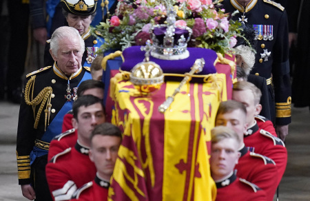 King Charles III and members of the royal family follow the coffin of Queen Elizabeth II, draped in the Royal Standard with the Imperial State Crown and the Sovereign's orb and sceptre, as it is carried out of Westminster Abbey after her State Funeral on September 19, 2022.