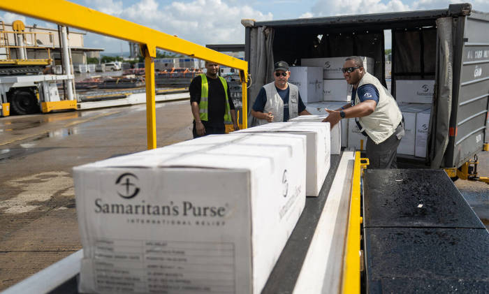 Samaritan’s Purse team members unload relief supplies air lifted to Puerto Rico.