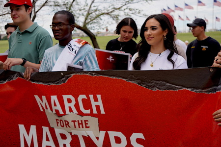 Participants in the 2022 March For The Martyrs hold a banner and walk together in solidarity for persecuted Christians globally, Sept. 24, 2022.