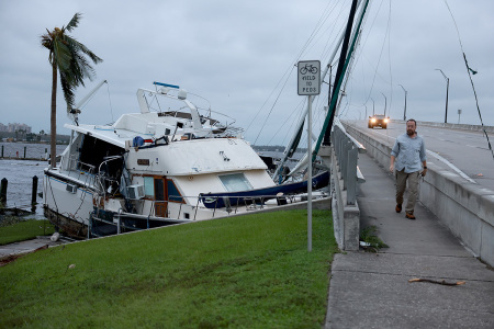 Boats are pushed up on a causeway after Hurricane Ian passed through the area on September 29, 2022, in Fort Myers, Florida. The hurricane brought high winds, storm surge and rain to the area causing severe damage.