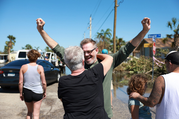 Douglas Jensen hugs his neighbor Sue Lepisto after they saw each other when they came to visit what was left of their homes after hurricane Ian passed through on Sept. 30, 2022, in Fort Myers, Florida. Their homes were flooded with about 6 feet of water. The hurricane brought high winds, storm surges and rain to the area causing severe damage.
