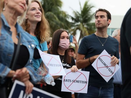 People stand together during an interfaith Rally Against Anti-Semitism hosted by Greater Miami Jewish Federation at the Holocaust Memorial on June 03, 2021 in Miami Beach, Florida.