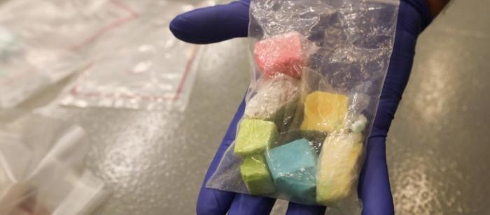 A plastic bag containing rainbow-colored fentanyl. 