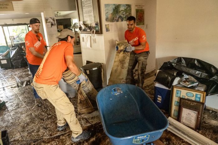 Volunteers with the charitable organization Samaritan's Purse help clean out a southwest Florida home damaged by Hurricane Ian.