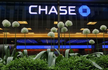 Flowers stand in front of a Chase sign at a bank branch inside the JPMorgan Chase headquarters on May 14, 2012, in New York City.