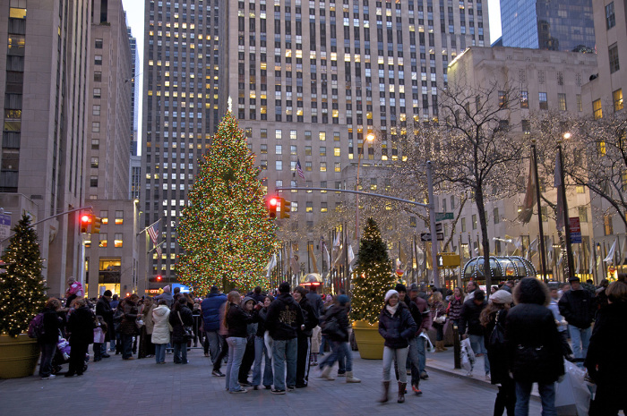 People viewing the Christmas tree at Rockefeller Center at dusk, New York City, New York. 