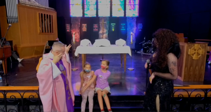Allendale United Methodist Church Senior Pastor Andy Oliver (left) and drag queen Isaac Simmons who goes by the name 'Ms. Penny Cost' talk to two young girls at church on Oct. 2, 2022. 