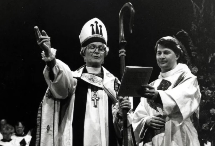 Mary Adelia McLeod, the first female diocesan bishop in the history of The Episcopal Church, blessing the people at her consecration on Nov. 1, 1993, while her son, the Rev. Harrison M. McLeod, is beside her. 