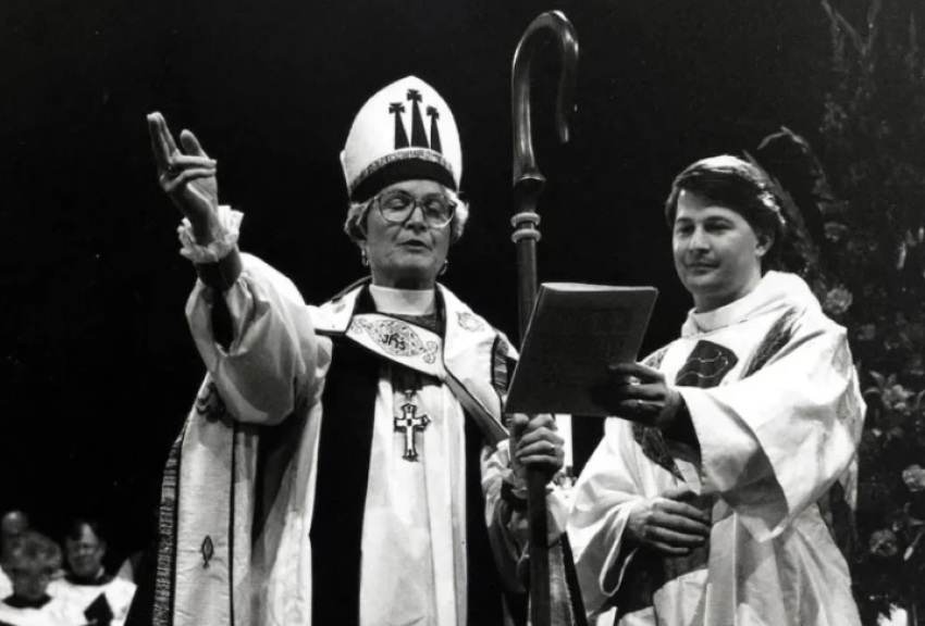 Mary Adelia McLeod, the first female diocesan bishop in the history of The Episcopal Church, blessing the people at her consecration on Nov. 1, 1993, while her son, the Rev. Harrison M. McLeod, is beside her.