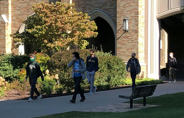 Students wear masks on the campus of Notre Dame University in South Bend, Indiana, on Oct. 6, 2020. 