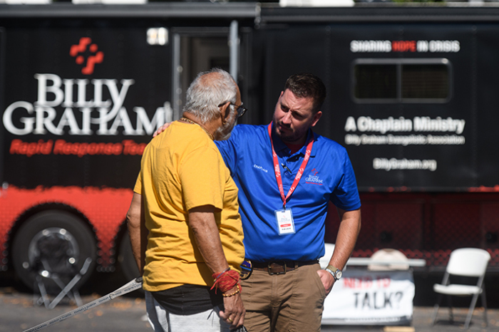 A Billy Graham Rapid Response Team chaplain speaks with a resident of Raleigh, North Carolina, after a mass shooting took five lives on Oct. 13, 2022. 