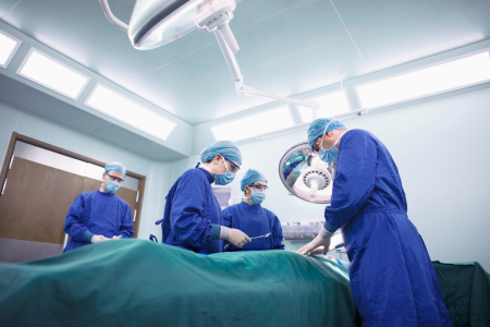 Operating room staff perform a surgery.