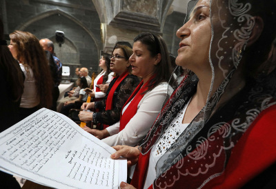 Iraqi Orthodox Christians celebrate Easter Saturday at the church of the ancient Mar Matta monastery of Saint Matthew in the village of Bashiqa, some 30km northeast of the northern Iraqi city of Mosul, during the night of April 23, 2022. 