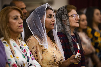 Christian worshipers attend an Orthodox Easter service at the Syriac Orthodox Church of Virgin Mary in the Kurdish-majority city of Qamishli in Syria's northeastern Hasakeh province on April 24, 2022. 