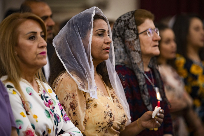 Christian worshippers attend an Orthodox Easter service at the Syriac Orthodox Church of Virgin Mary in the Kurdish-majority city of Qamishli in Syria's northeastern Hasakeh province on April 24, 2022. 