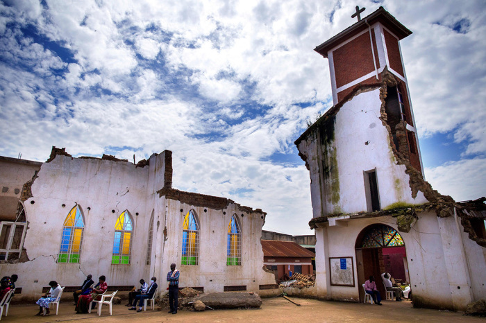 Believers attend their Christmas prayer at St. Peter's Church, which was demolished four months ago over ownership of the land and now is on trial, in Kampala, Uganda, on Dec. 25, 2020. 