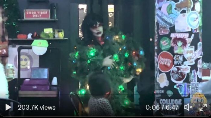 Screenshot from video of a Texas drag show showing a man dressed as a woman performing in front of a small child.