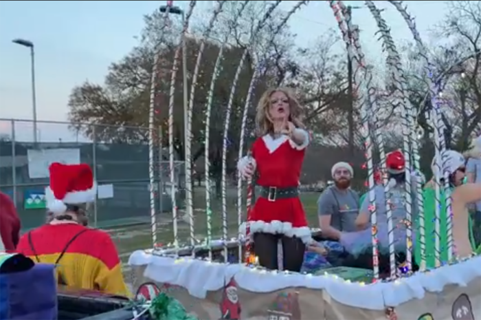 A man dressed in drag lip singing to Mariah Carey's 'All I Want For Christmas Is You' at a Christmas parade in Taylor, Texas, December 2021. 