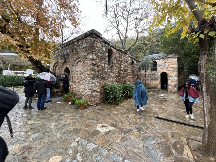 Tourists line up in the rain to see inside the House (Shrine) of Mary in Izmir on December 2, 2022. It was built in an area believed to be where the Christian icon spent her final days.