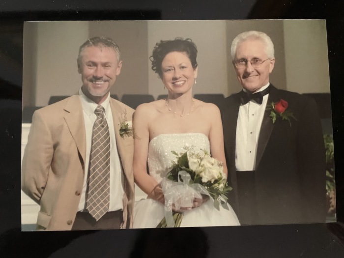 Pastor James Slick (left) is pictured with Sandra and Jack Abbott on their wedding day. 