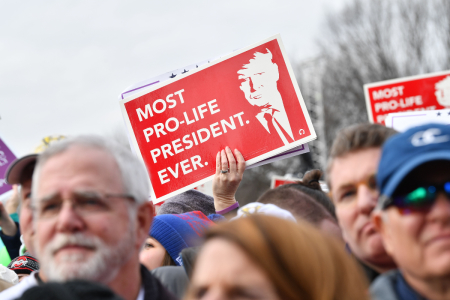 Pro-life demonstrators hold 'Most Pro-Life President Ever' signs during the 47th annual 'March for Life' in Washington, DC, on Jan. 24, 2020.