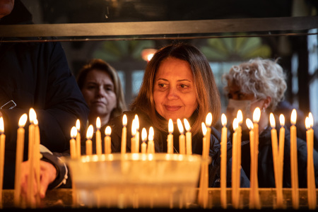 A woman lights a candle at the Patriarchal church of St. George, as part of Epiphany day celebrations at the Church of Fener Orthodox Patriarchate on January 06, 2023, in Istanbul, Turkey. Epiphany celebrates the baptism of Jesus Christ by John the Baptist, and falls on the 12th and final day of Christmas.