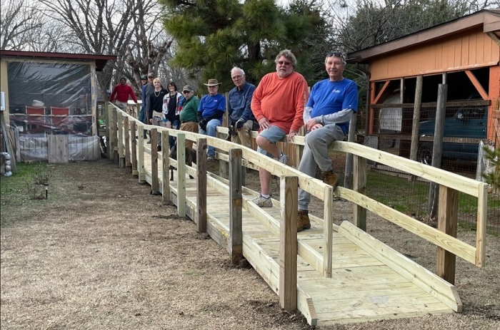 The Reidland United Methodist Men Ramp Ministry, based in Paducah, Kentucky, is pictured here on the 1,000th ramp that they have built, which was completed on Wednesday, Jan. 11, 2023. From left to right: Keith Williams, Jason Nichols, Vince Kahne, Morison Williams, Mallory Williams, Danny Morris, Chuck Bearden, Ed Bach, Jason Moore, and Joe Burkhead.