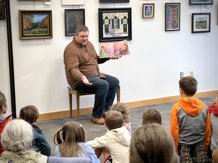Pastor Kendall Lankford reads a book to children at the Chelmsford Public Library on Friday, Jan. 13, 2022.