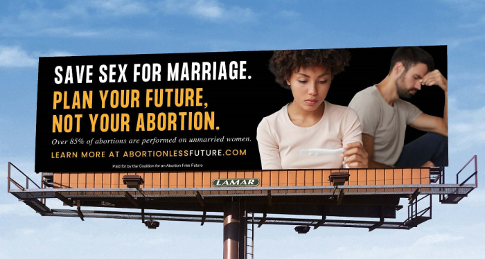 A billboard sponsored by the Life Legal Defense Foundation shows a woman looking at the results of a pregnancy test. 