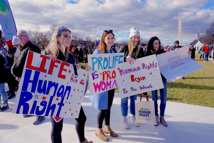 Four young adult pro-life demonstrators march in the March for Life on Jan. 20, 2023, in Washington, D.C.
