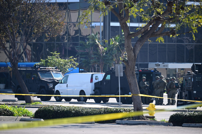Law enforcement personnel are seen outside the site in Torrance, California, where the alleged suspect in the mass shooting in which 10 people were killed in Monterey Park, California, is believed to be holed up on Jan. 22, 2023. 