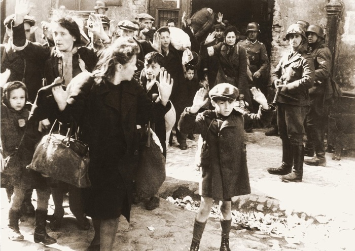 A Jewish boy surrenders during the Warsaw Ghetto Uprising of 1943. After the uprising was crushed, the Nazis sent the survivors to concentration camps. 