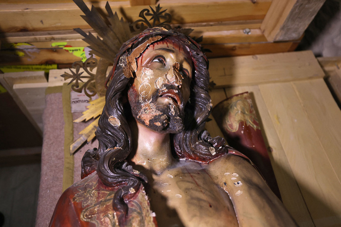 A picture shows a wooden statue of Jesus that was pulled down and damaged in the Church of the Condemnation, where Christians believe Jesus was flogged and sentenced to death, in Jerusalem's Old City on February 2, 2023. - Israeli police said officers arrested an American man today over vandalizing the church along a major pilgrimage route in Jerusalem's Old City. 'The suspect arrested is an American tourist in his 40s, who vandalized and broke a statue in the church,' said a statement from the Israeli police, adding that the man's mental health was being assessed. A spokeswoman for the United States embassy in Jerusalem did not comment on the incident when contacted by AFP. 