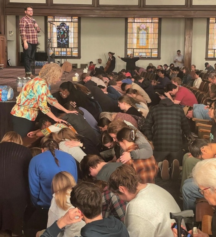 Students crowd the altar at Hughes Auditorium at Asbury University during a revival event that began on Wednesday, Feb. 8, 2023. 
