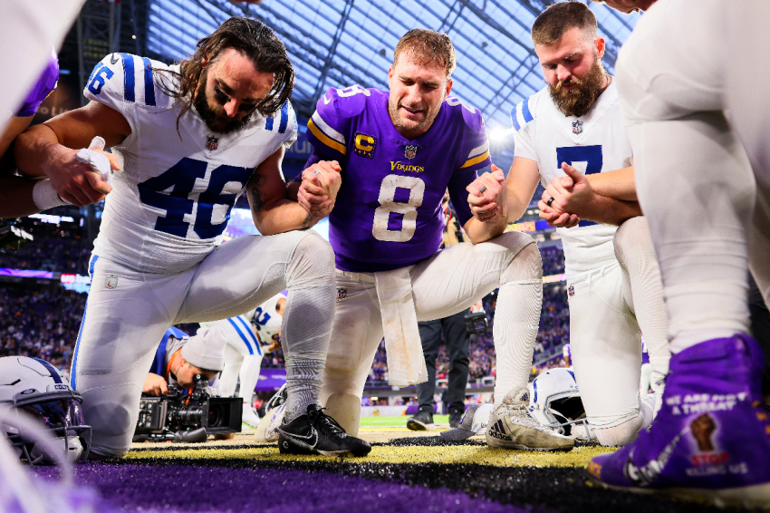 Kirk Cousins #8 of the Minnesota Vikings prays with Indianapolis Colts players after their game at U.S. Bank Stadium on December 17, 2022 in Minneapolis, Minnesota.