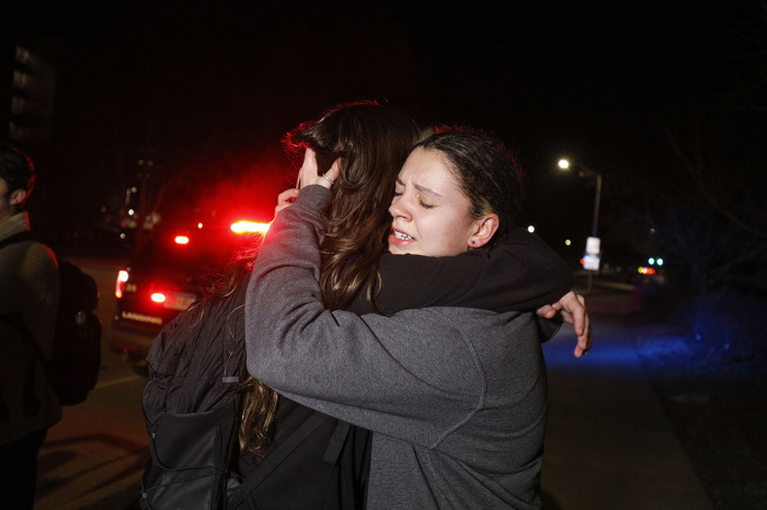 Michigan State University students hug during an active shooter situation on campus on February 13, 2023, in Lansing, Michigan. . 