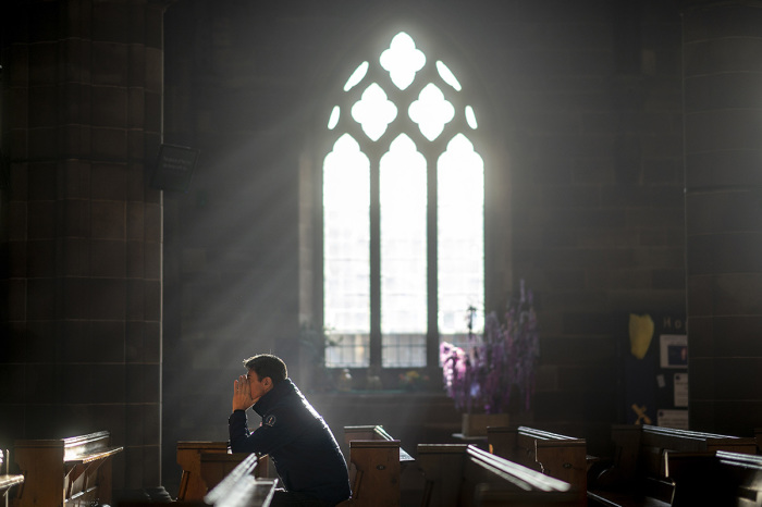A man prays in a church in Birmingham, England. 