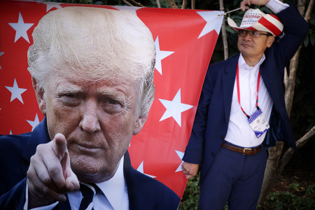 Supporter Tien Tran of San Diego, California, holds a Trump banner during the annual Conservative Political Action Conference (CPAC) at Gaylord National Resort & Convention Center on March 4, 2023, in National Harbor, Maryland. Former President Donald Trump will address the event this afternoon.