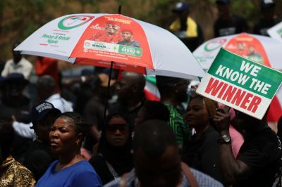 Supporters of Nigerias Peoples Democratic Party carry a placard during a protest at Independent National Electoral Commission (INEC) headquarters, over the results of Nigerias 2023 presidential and general election in Abuja on March 6, 2023. 