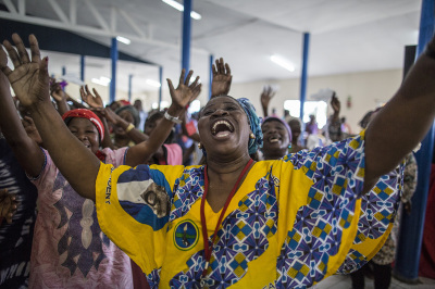 Women dance and sing during the Sunday service at the Nazareth Evangelical Church on September 4, 2016. 