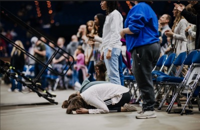 Attendees participate in a revival event organized by the young adult ministry Pulse on Sunday, Feb. 26, 2023, at the Rupp Arena in Lexington, Kentucky. 