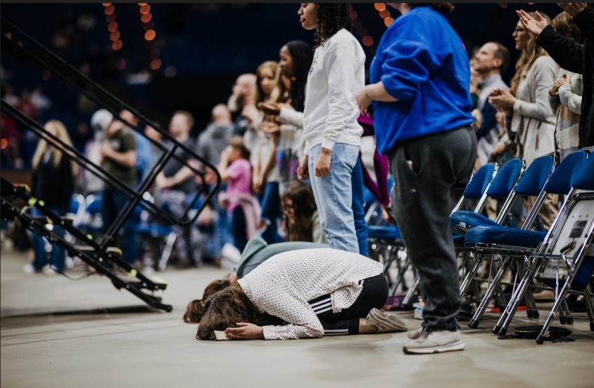 Attendees participate in a revival event organized by the young adult ministry Pulse on Sunday, Feb. 26, 2023, at the Rupp Arena in Lexington, Kentucky.