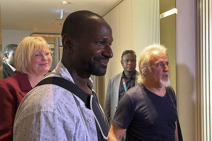 French journalist Olivier Dubois (3rd L), freed nearly two years after he was kidnapped by the Support Group for Islam and Muslims (GSIM) in Mali, and US national Jeffery Woodke (R), freed after being kidnapped in October 2016 in Niger, are seen as they arrive at the Diori Hamani International Airport in Niamey, Niger, on March 20, 2023. (Photo by Souleymane AG ANARA / AFP) (Photo by SOULEYMANE AG ANARA/AFP via Getty Images) 
