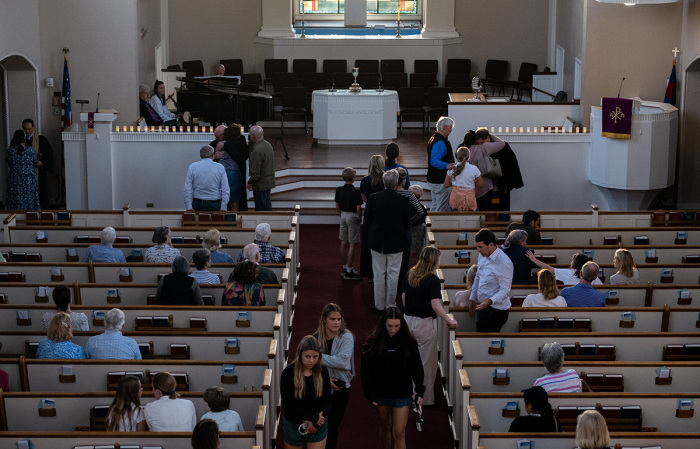 People attend a vigil at Woodmont Christian for those who were killed in a mass shooting at The Covenant School on March 27, 2023, in Nashville, Tennessee. According to initial reports, three students and three adults were killed by the shooter, a 28-year-old woman who self-identified as trans. The shooter was killed by police responding to the scene. 