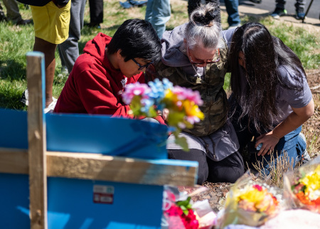 Mourners pray at the entrance of The Covenant School on March 28, 2023, in Nashville, Tennessee. Three students and three adults were killed by the 28-year-old trans-identified shooter on Monday.