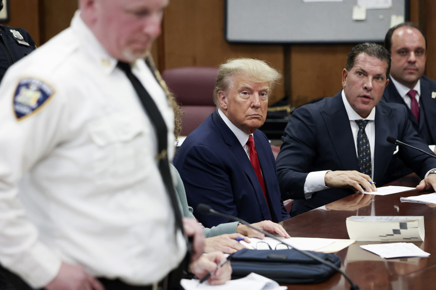 Former U.S. President Donald Trump sits in the courtroom with his attorneys Joe Tacopina and Boris Epshteyn (R) during his arraignment at the Manhattan Criminal Court on April 4, 2023, in New York City. Trump pleaded not guilty to 34 felony counts stemming from hush money payments made to adult film star Stormy Daniels before the 2016 presidential election. With his indictment, Trump will become the first former U.S. president in history to be charged with a criminal offense.