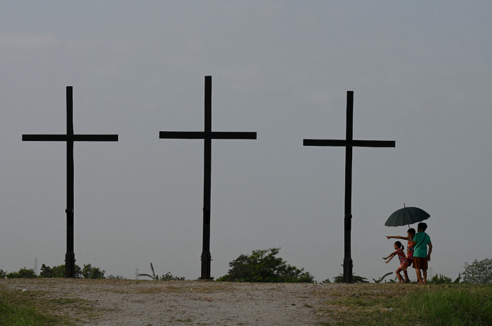 People visit the site where the re-enactment of the crucifixion of Jesus Christ will take place during Holy Week celebrations in San Fernando, Pampanga province on April 4, 2023. 